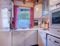 a kitchen with a stove top oven sitting next to a window